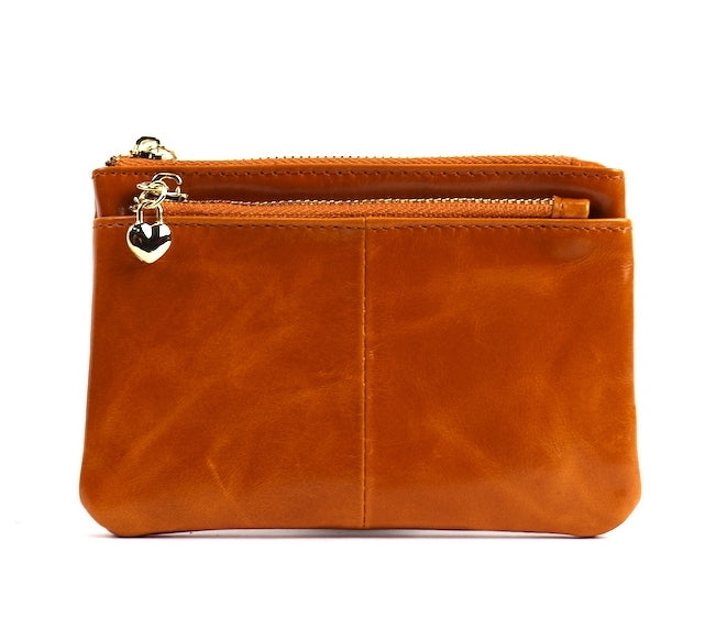 Light tan leather pouch with a silver zipper and key ring, angled view.