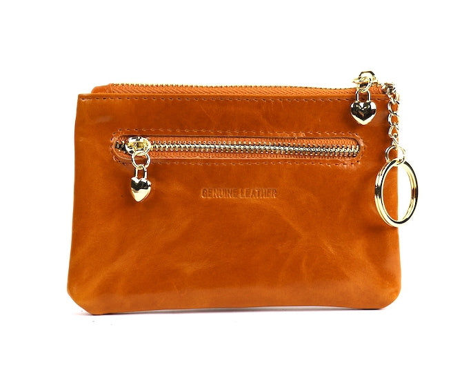 Light tan leather pouch with a silver zipper and key ring, angled view.