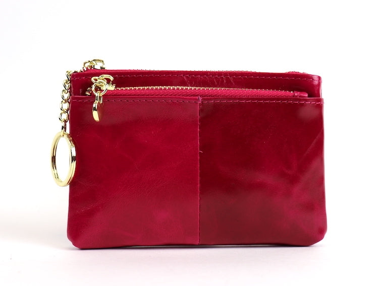 Fuchsia leather pouch with a silver zipper and key ring.