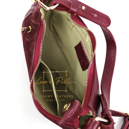 Maroon handbag with gold accents on a white background, featuring the 'Lusso in Pelle' brand.